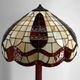 Art Deco floor lamp in carved walnut, stained glass shade, France, c. 1920