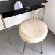 Brass hairdresser, glass and black plastic with its fluffy stool.