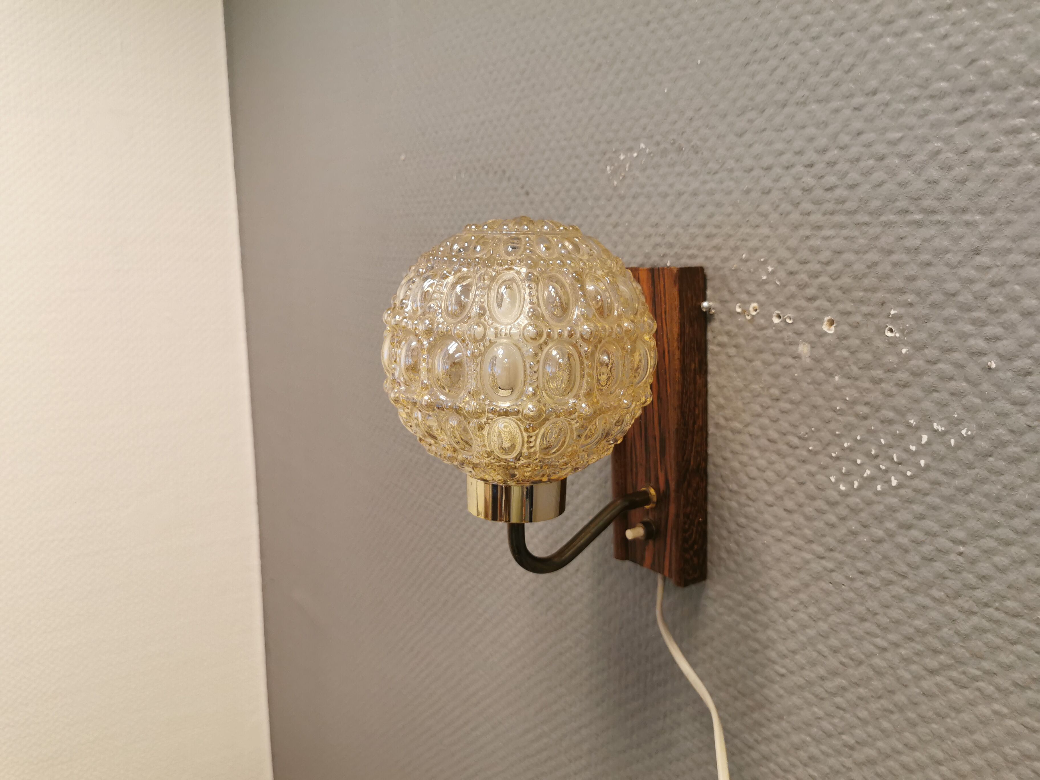 Wall light in rosewood with bobble glass ball shade.