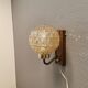 Wall light in rosewood with bobble glass ball shade.