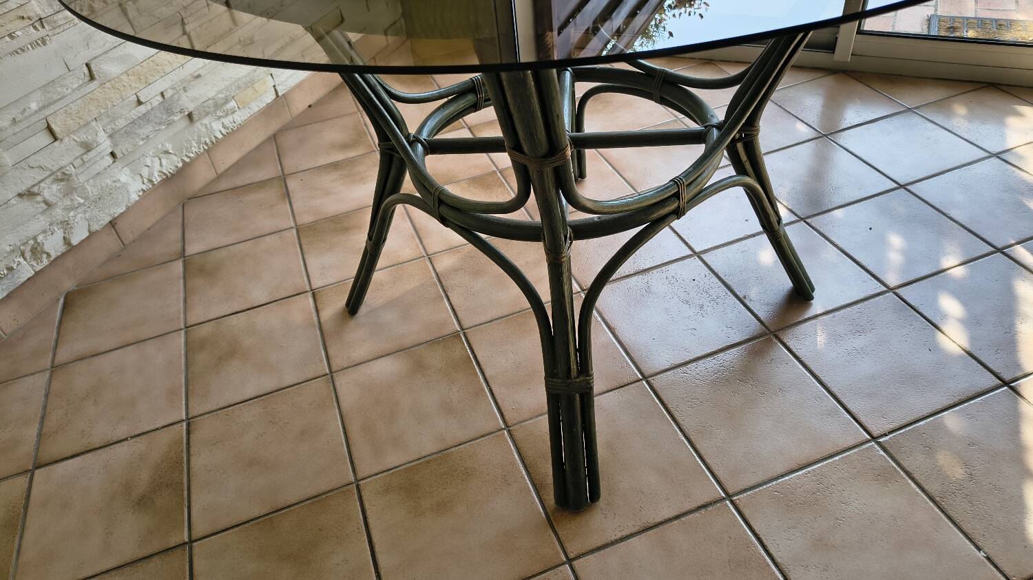 Round bamboo rattan table with a glass top.
