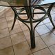 Round bamboo rattan table with a glass top.