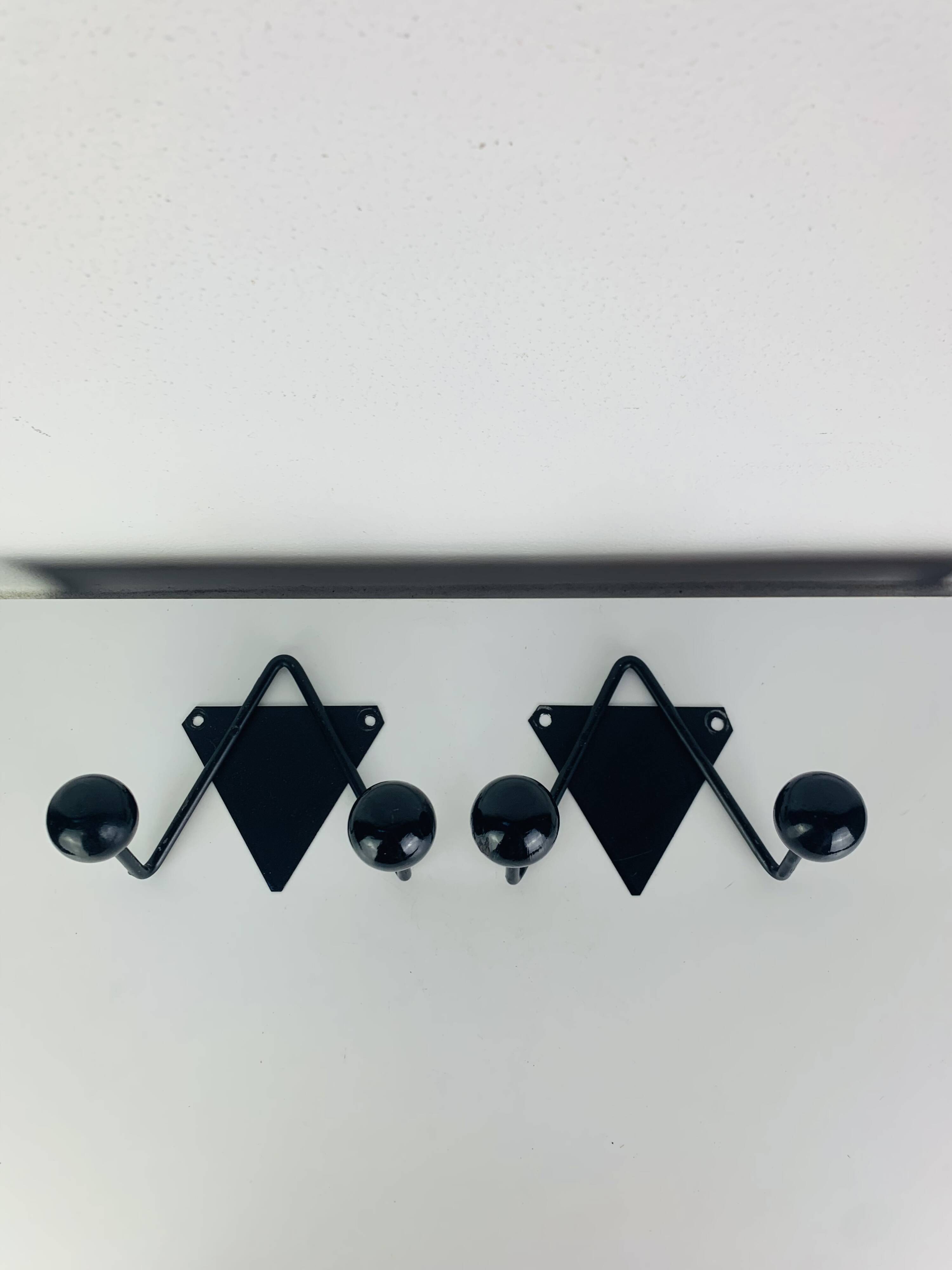 Pair of wall hooks from the 1950s, black metal