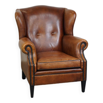 Beautiful sheepskin leather wingback armchair, with nails and black piping