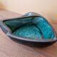 Ceramic ashtray with green and black glaze forming a pipe holder