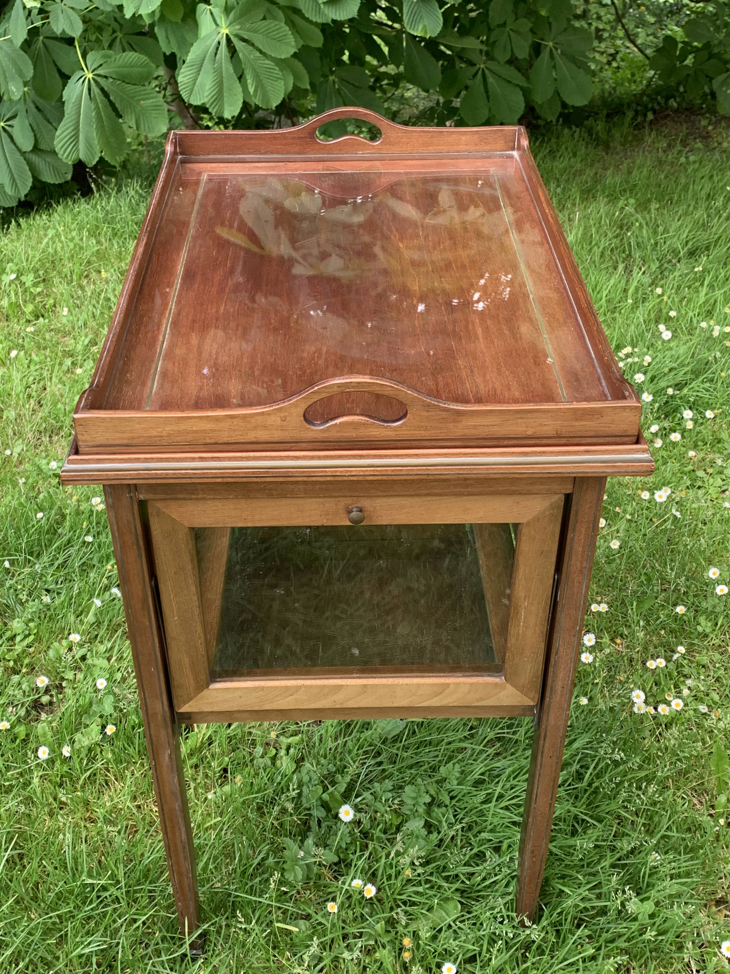 Glass-enclosed old tea table with wooden tray, bronze and brass