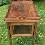 Glass-enclosed old tea table with wooden tray, bronze and brass