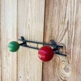 Vintage wall coat rack with 2 red and green wooden hooks