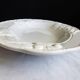 Oval white vegetable dish, an antique tableware piece in barbotine earthenware.