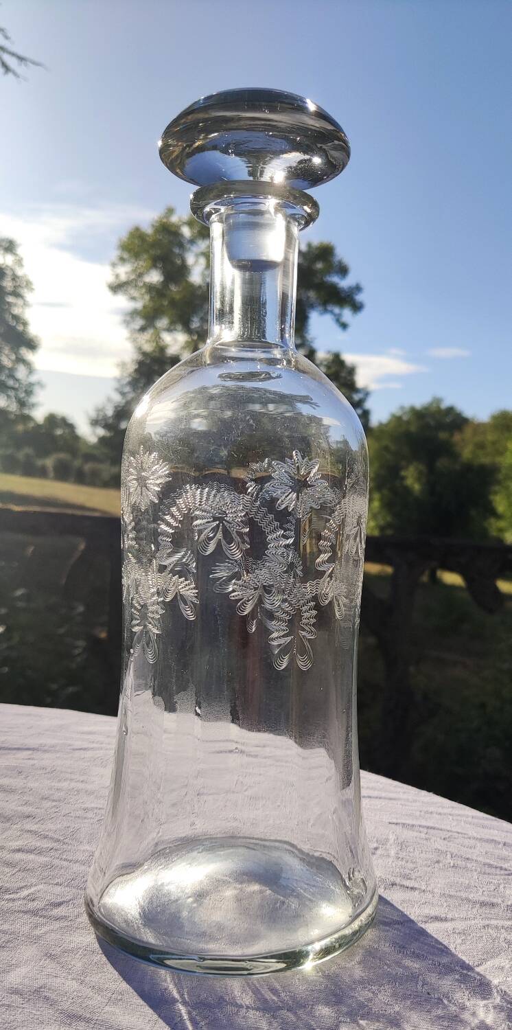 Two antique engraved glass bottles