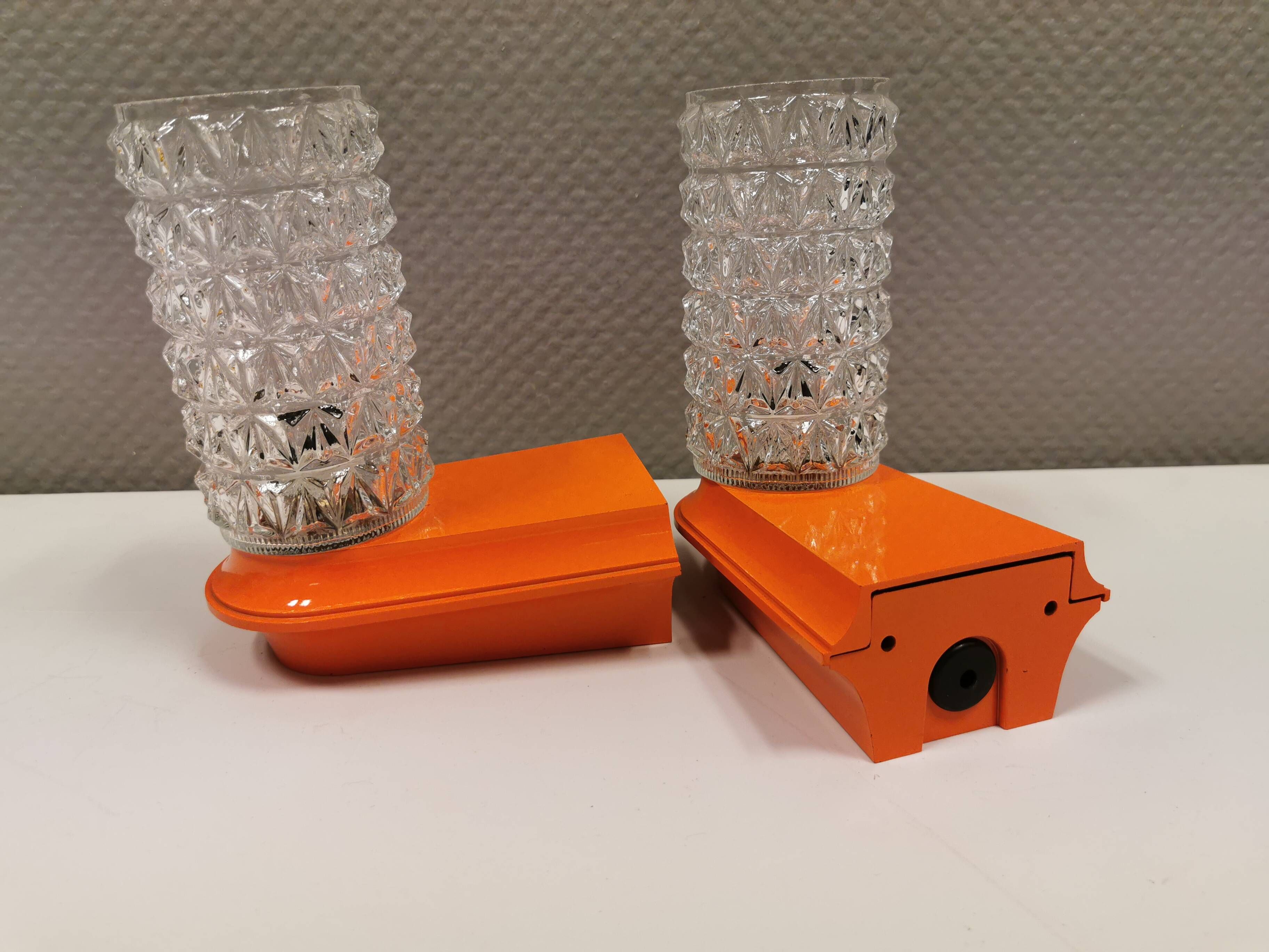 Bathroom lamps in a nice orange colour with a crystal glass shade and a base of hard thin plastic