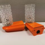 Bathroom lamps in a nice orange colour with a crystal glass shade and a base of hard thin plastic