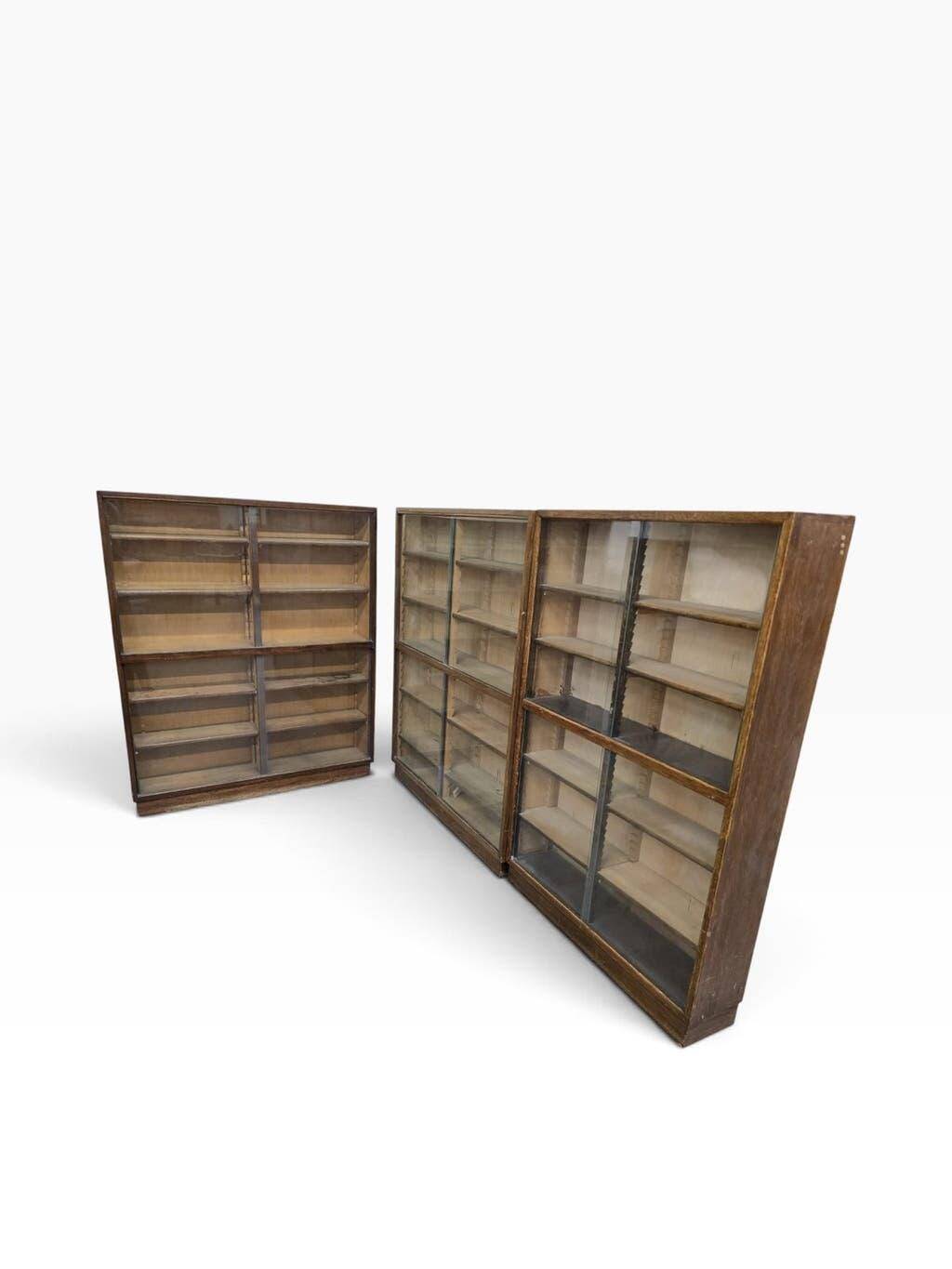 Vintage shallow wooden display shelf with sliding glass doors.