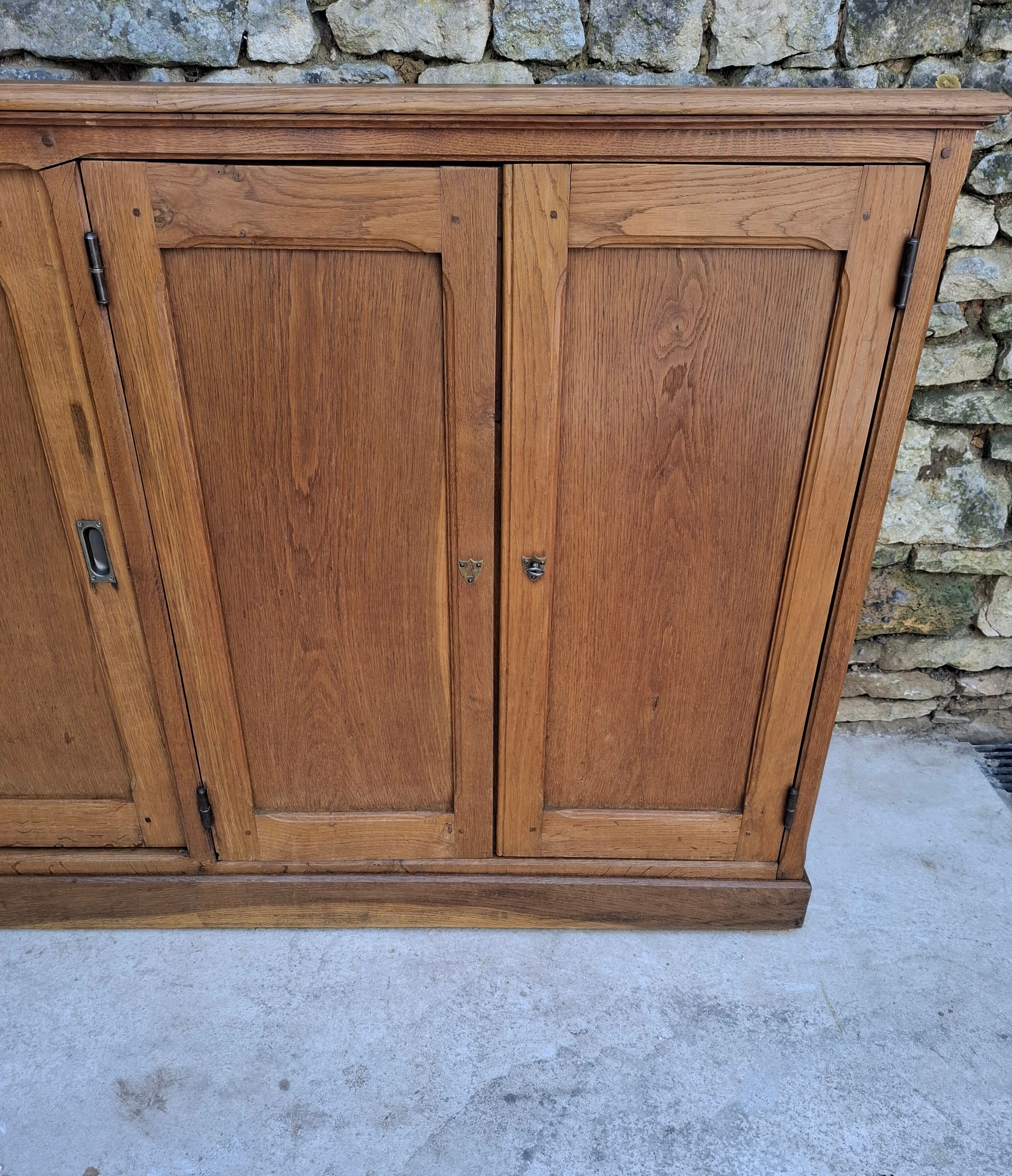 Oak workshop furniture with sliding doors.