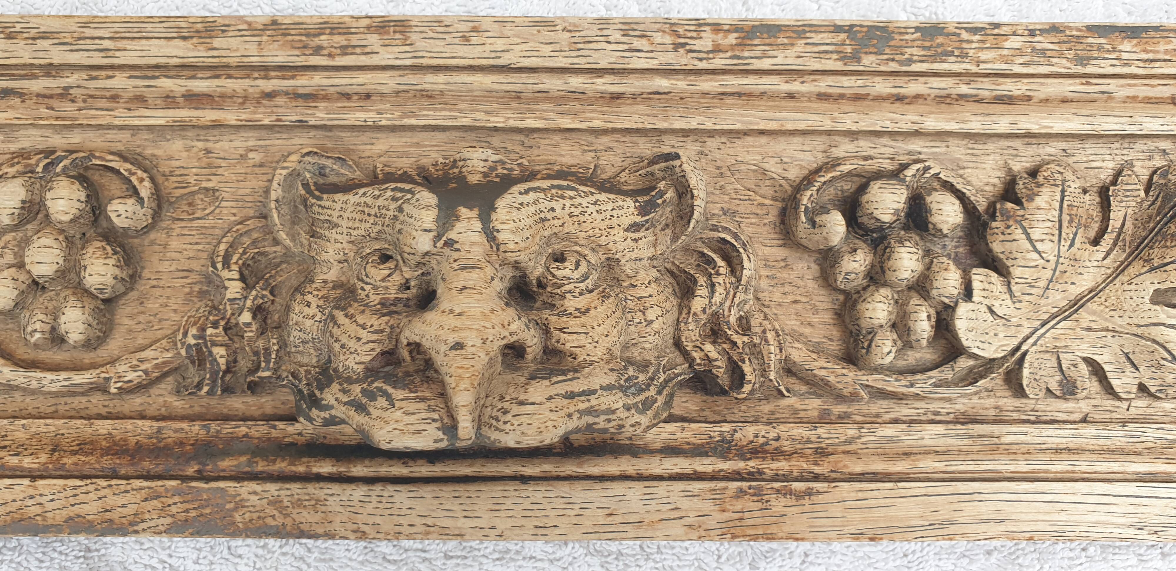 Natural wood pediment with bunches of grapes