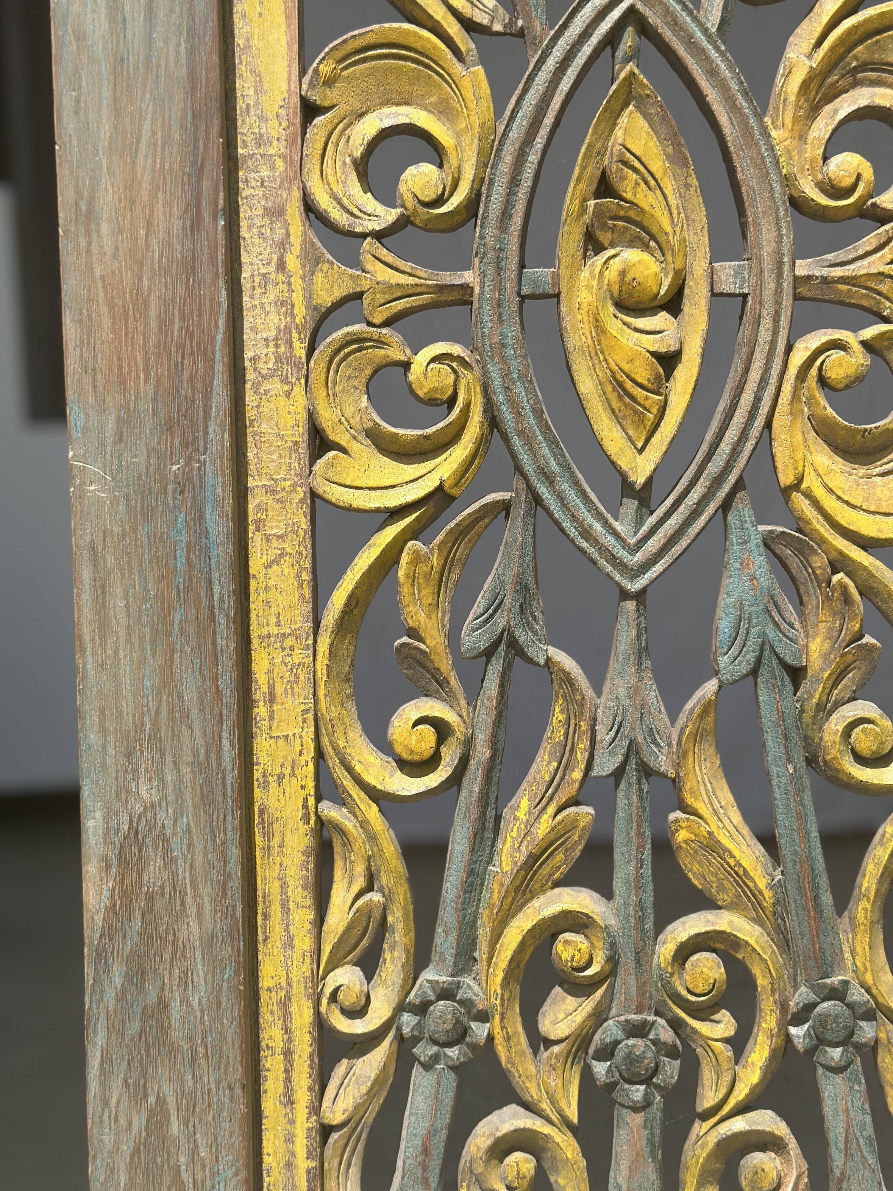 Rectangular Indonesian construction element with blue and yellow plant in carved wood