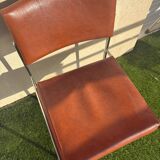 A pair of vintage brown Skaï chairs.