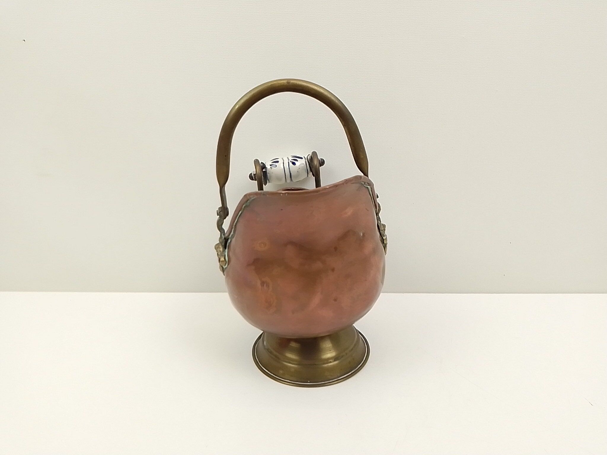 Copper pot cover and a pitcher-style brass handle