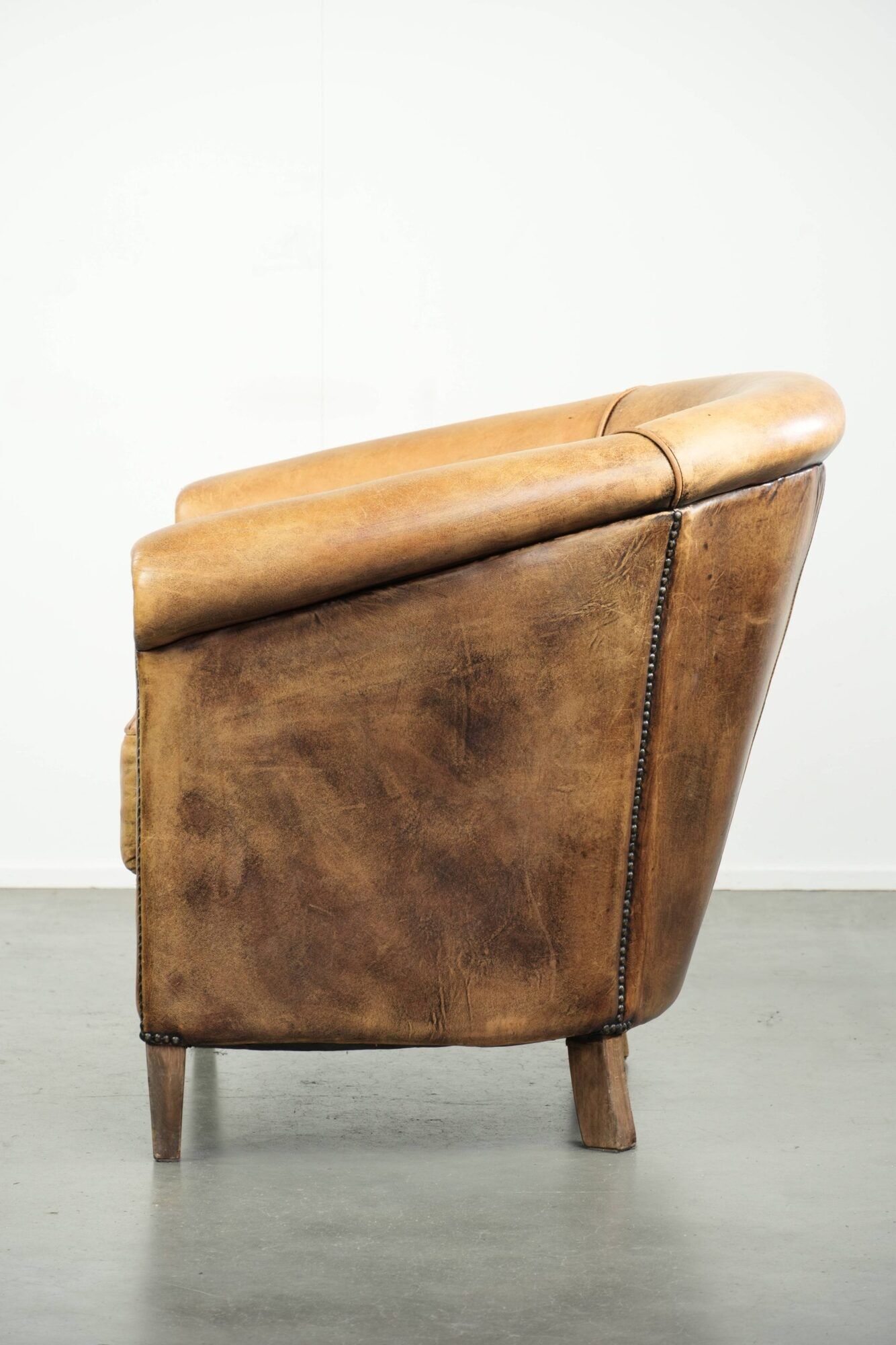 Vintage sheepskin club armchair in a light cognac colour