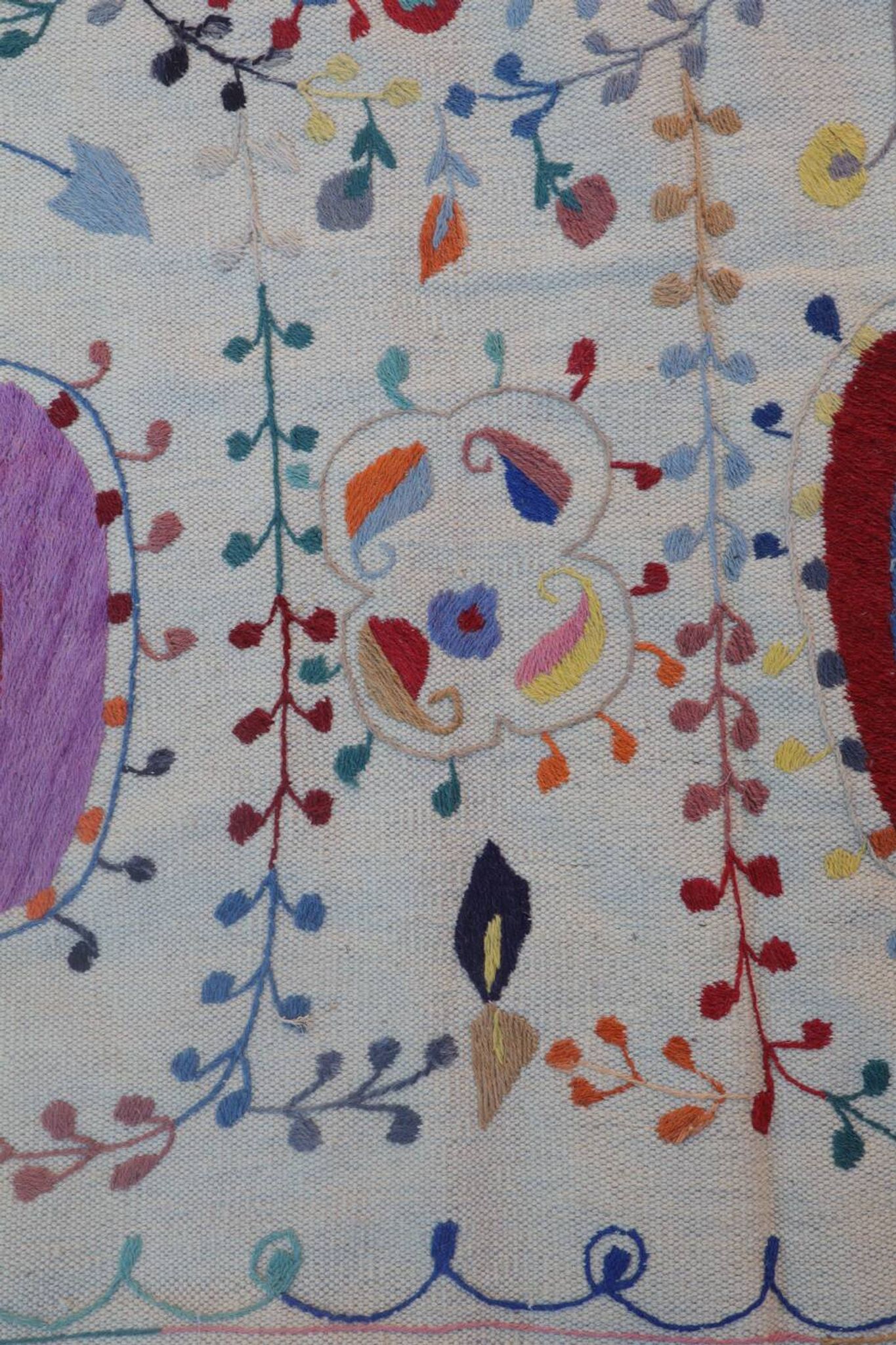 White suzani kilim rug with hand embroidered multi-colored patterns