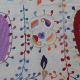 White suzani kilim rug with hand embroidered multi-colored patterns