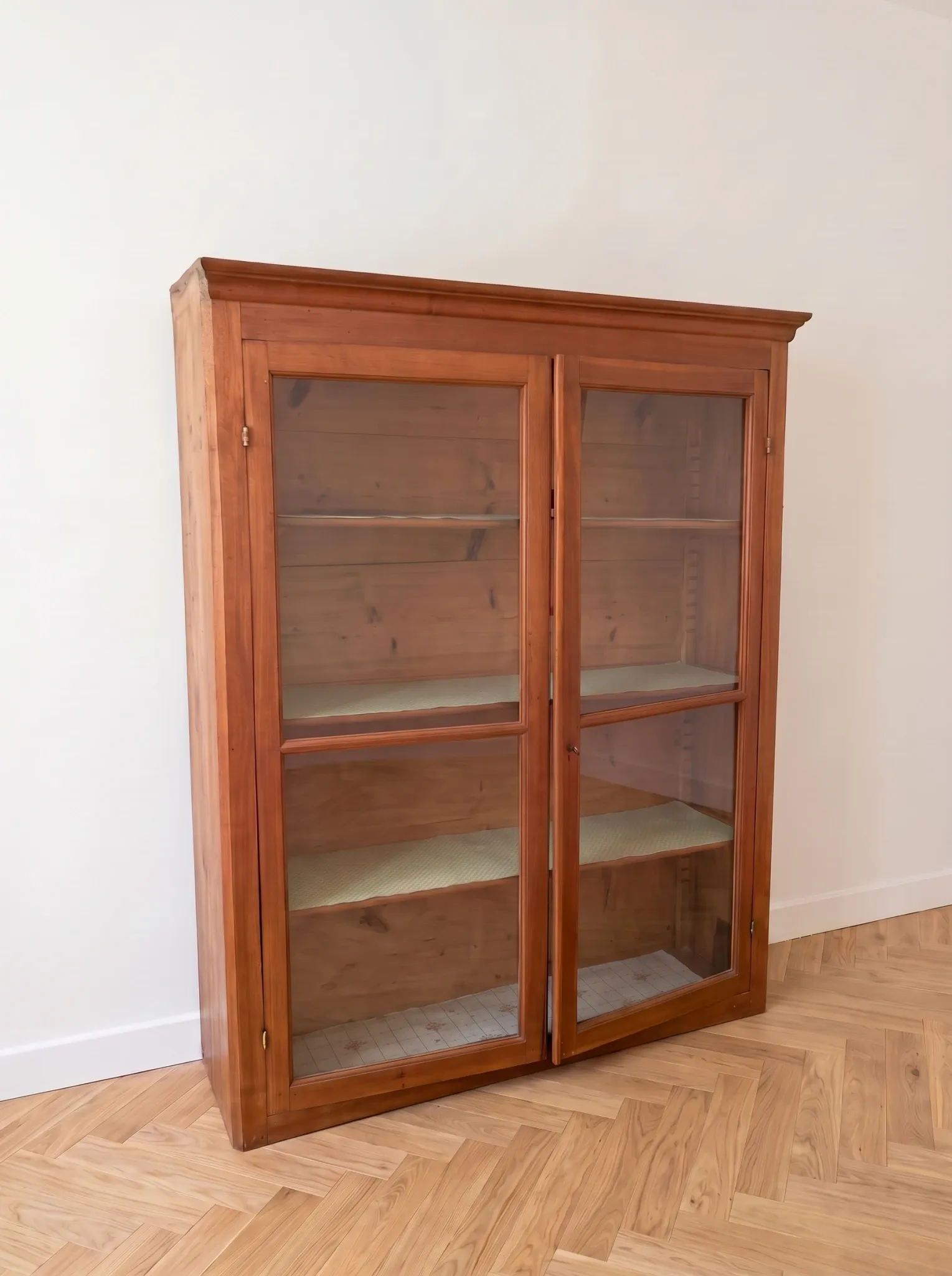 Antique wooden storage cabinet with display case.