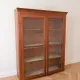 Antique wooden storage cabinet with display case.