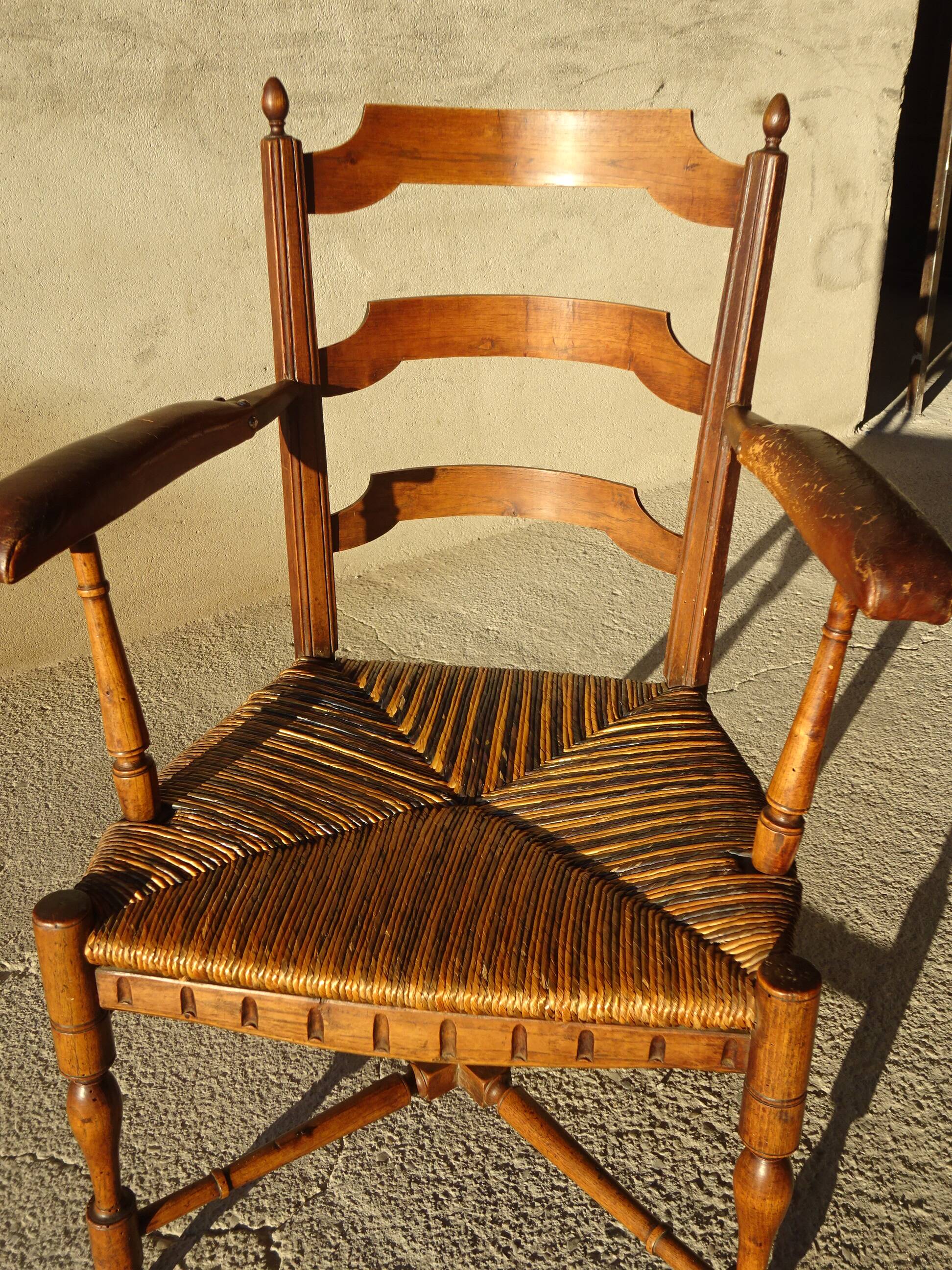 old armchair with leather armrests, from the 19th century