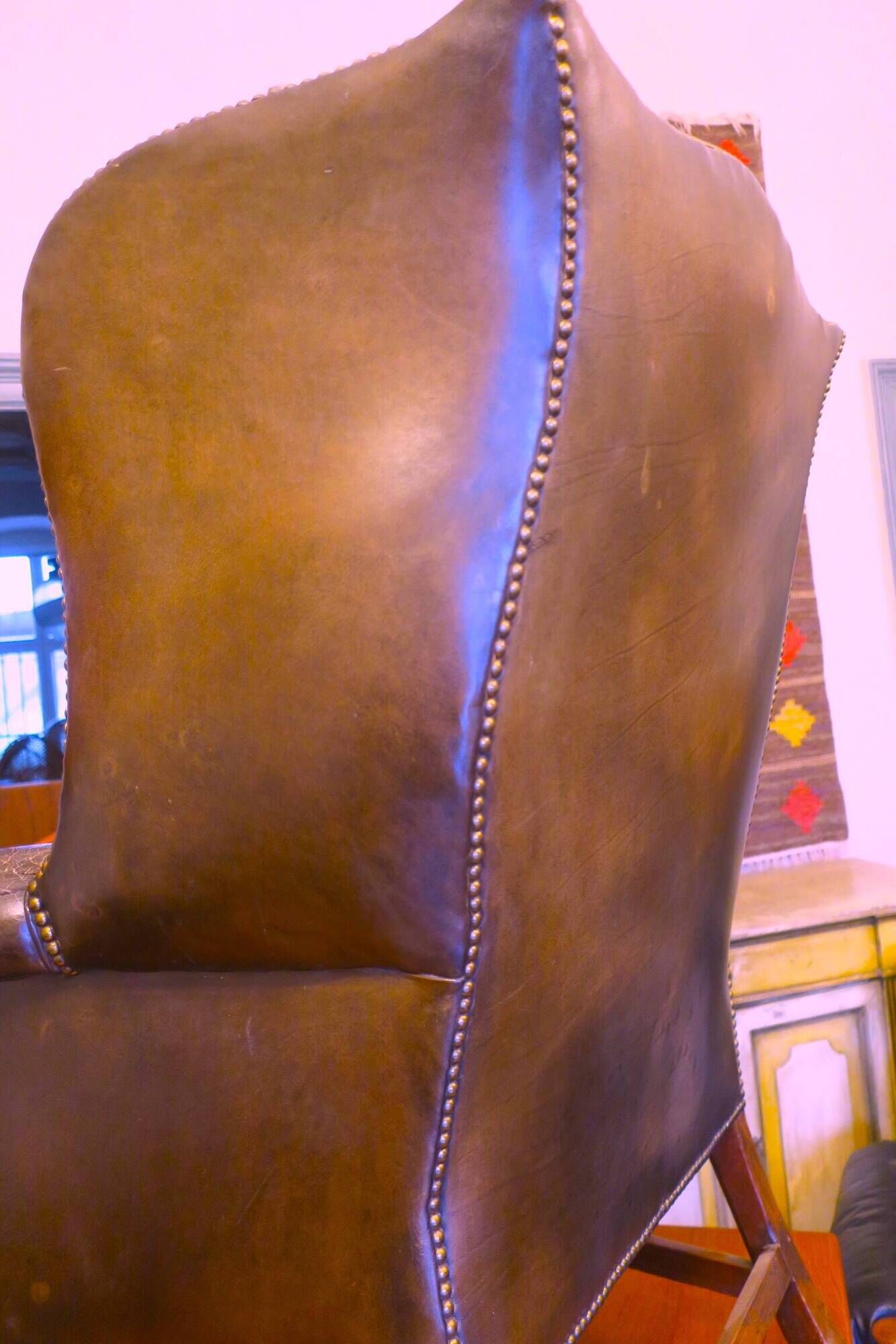 Wingback armchair in dark brown patinated leather, 1970s