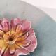 Decorative plate with relief floral pattern in majolica.