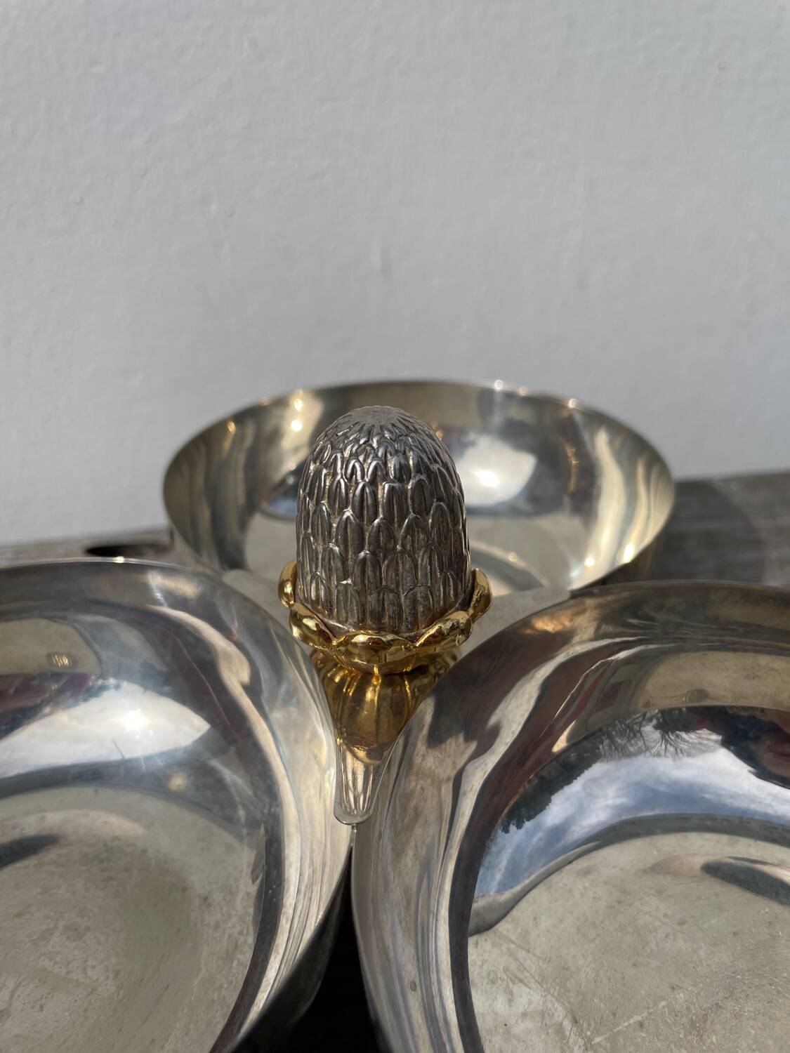 Silver-plated metal dish topped with an acorn