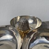 Silver-plated metal dish topped with an acorn