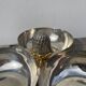 Silver-plated metal dish topped with an acorn