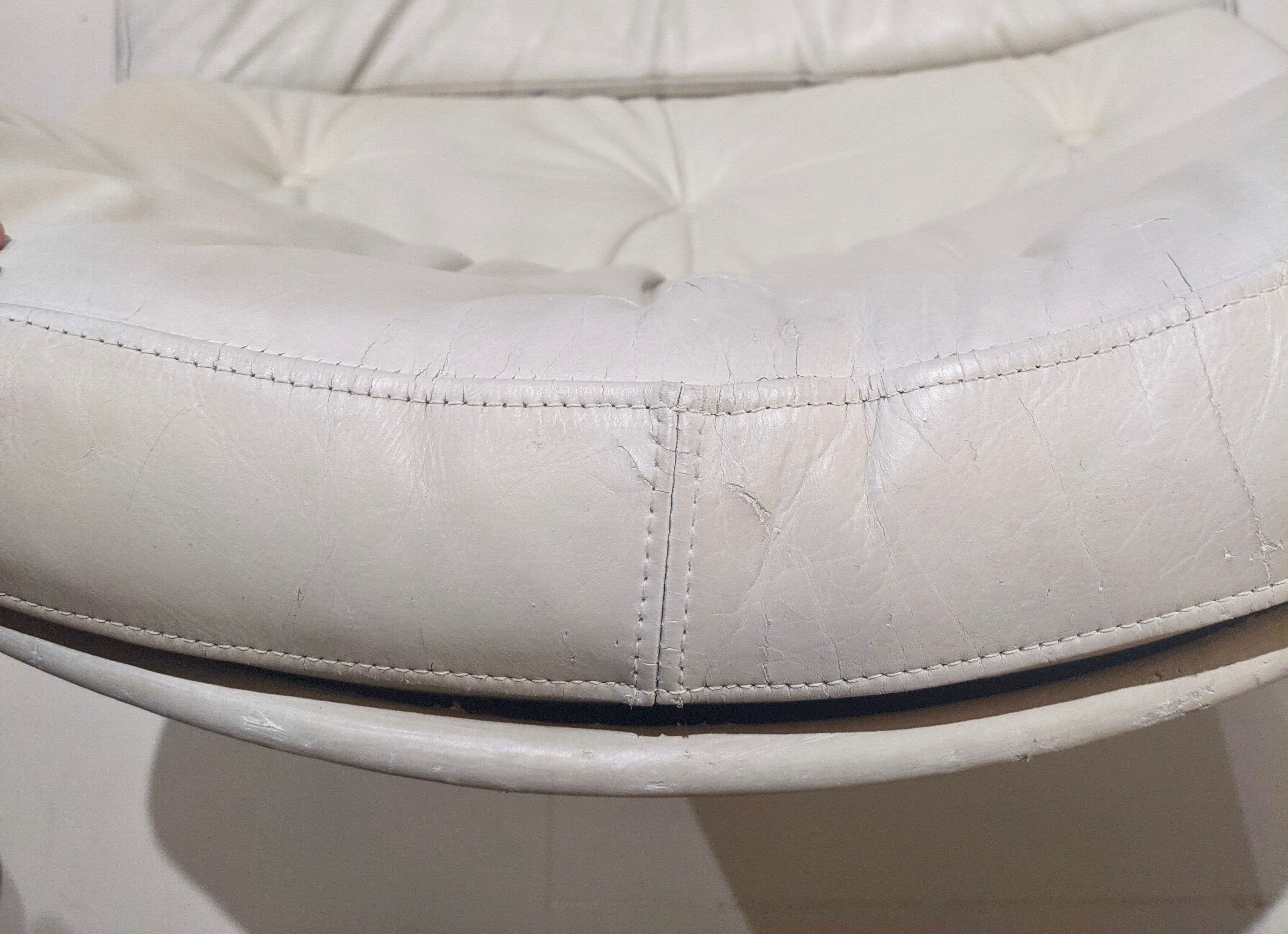 Swivel armchair in grey patinated leather