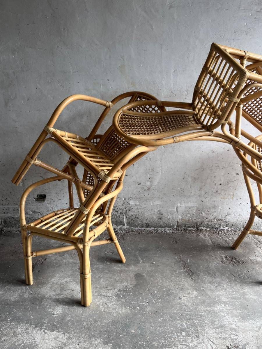 Set of 8 Manou rattan chairs with cane backrest.