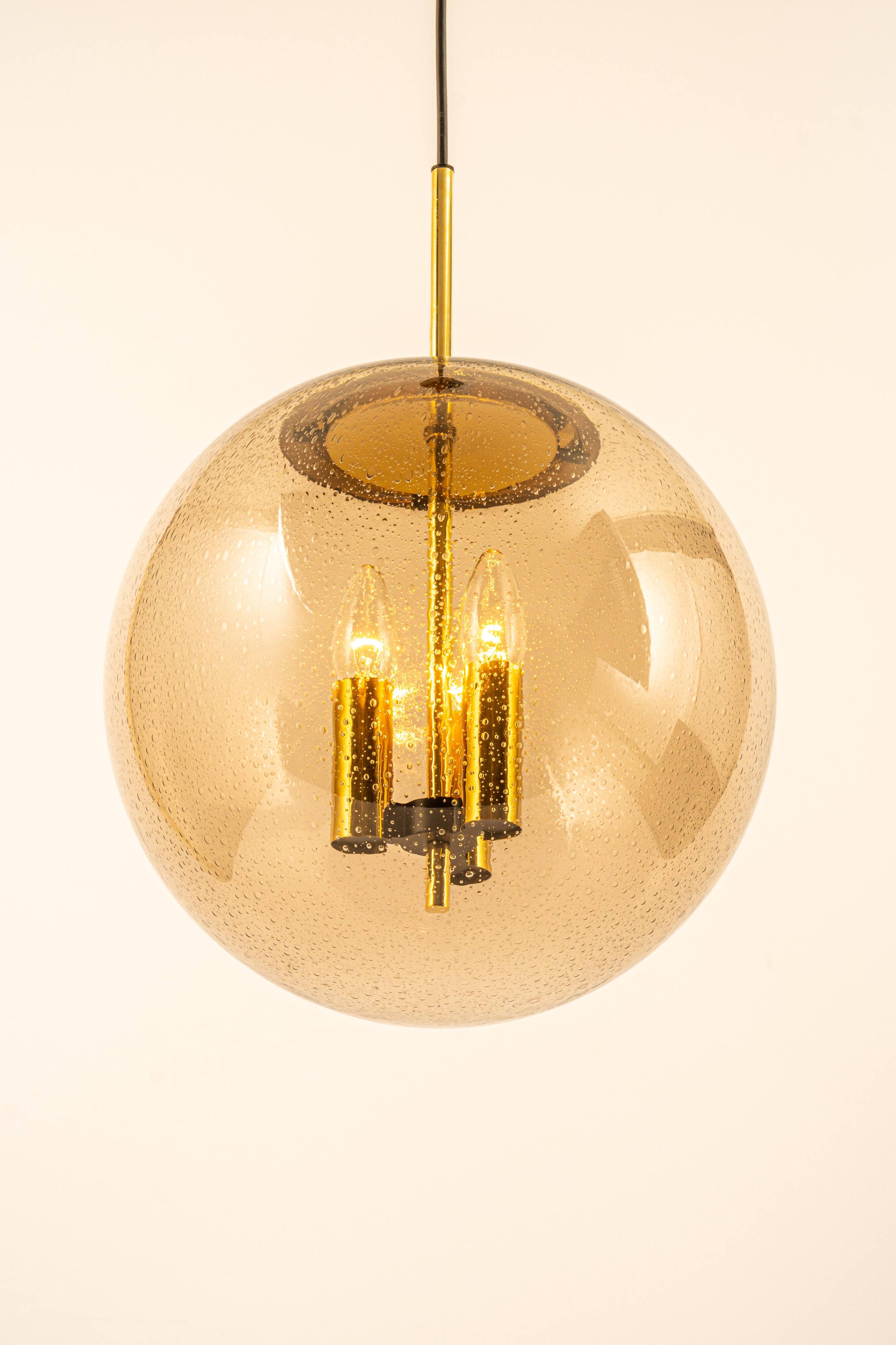 Large Limburg pendant light in brass with smoked glass ball, Germany, 1970s.