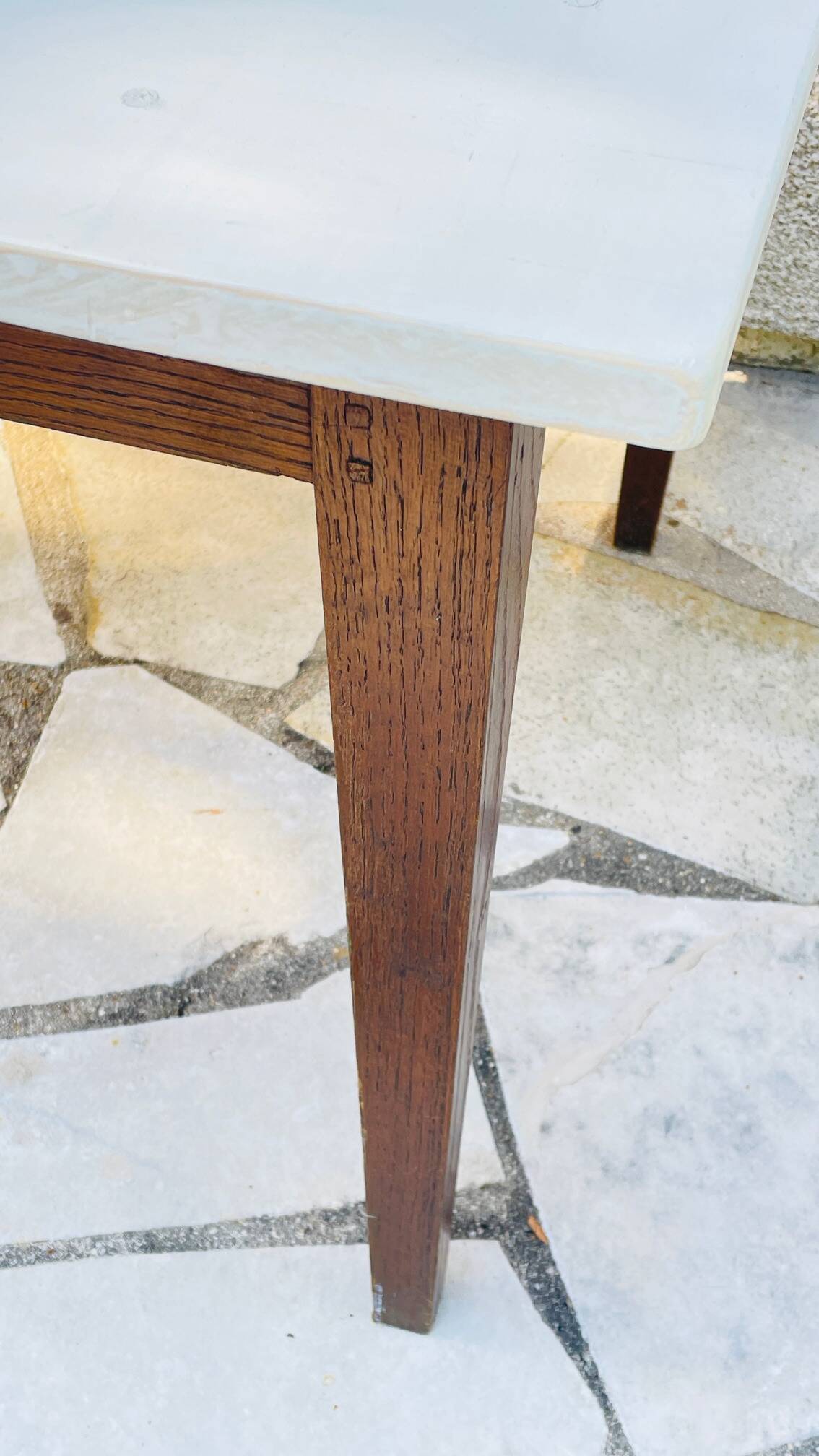 Vintage oak farmhouse table with a white top.
