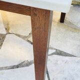 Vintage oak farmhouse table with a white top.