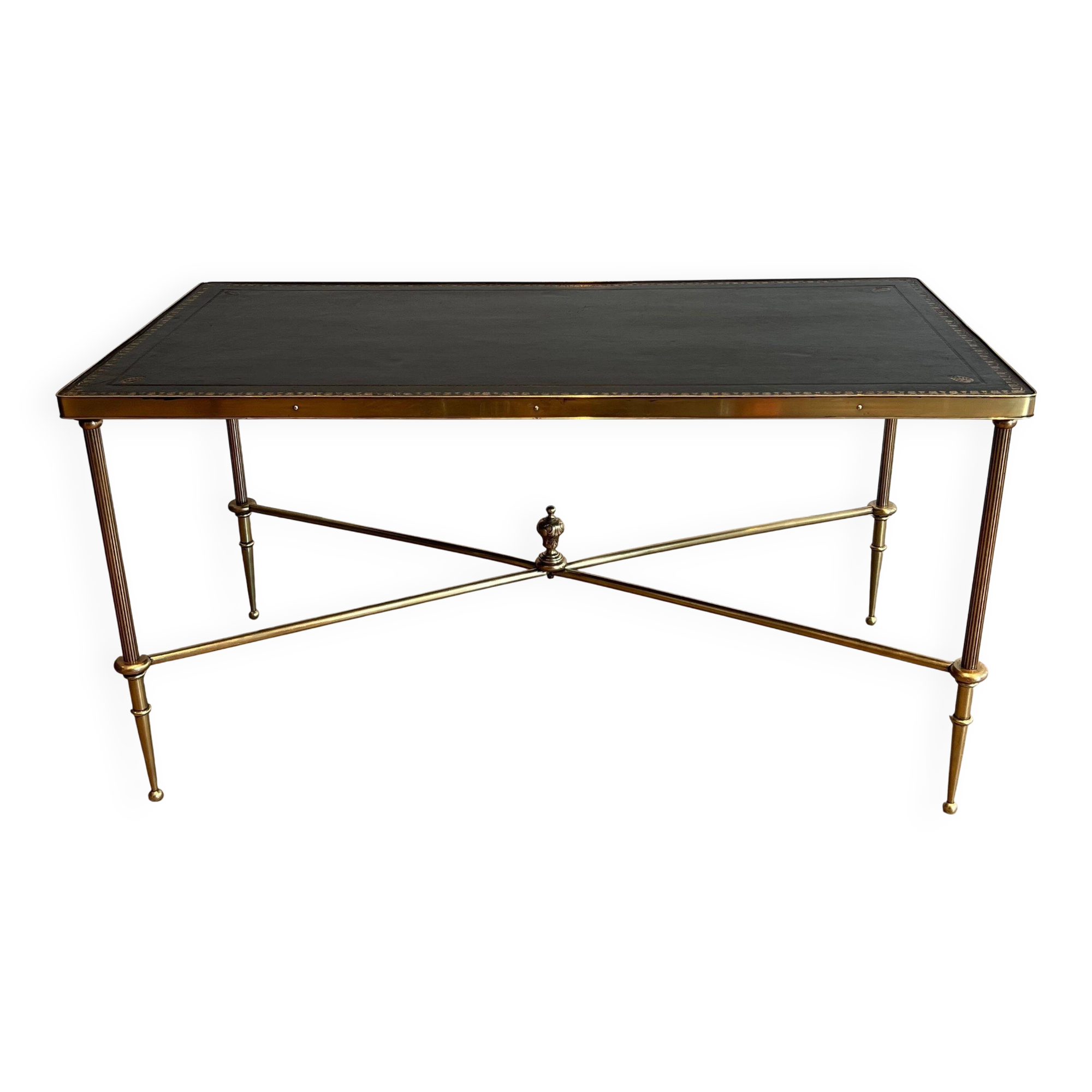 Neoclassical brass coffee table with a black leather top and golden borders from Maison Jansen.