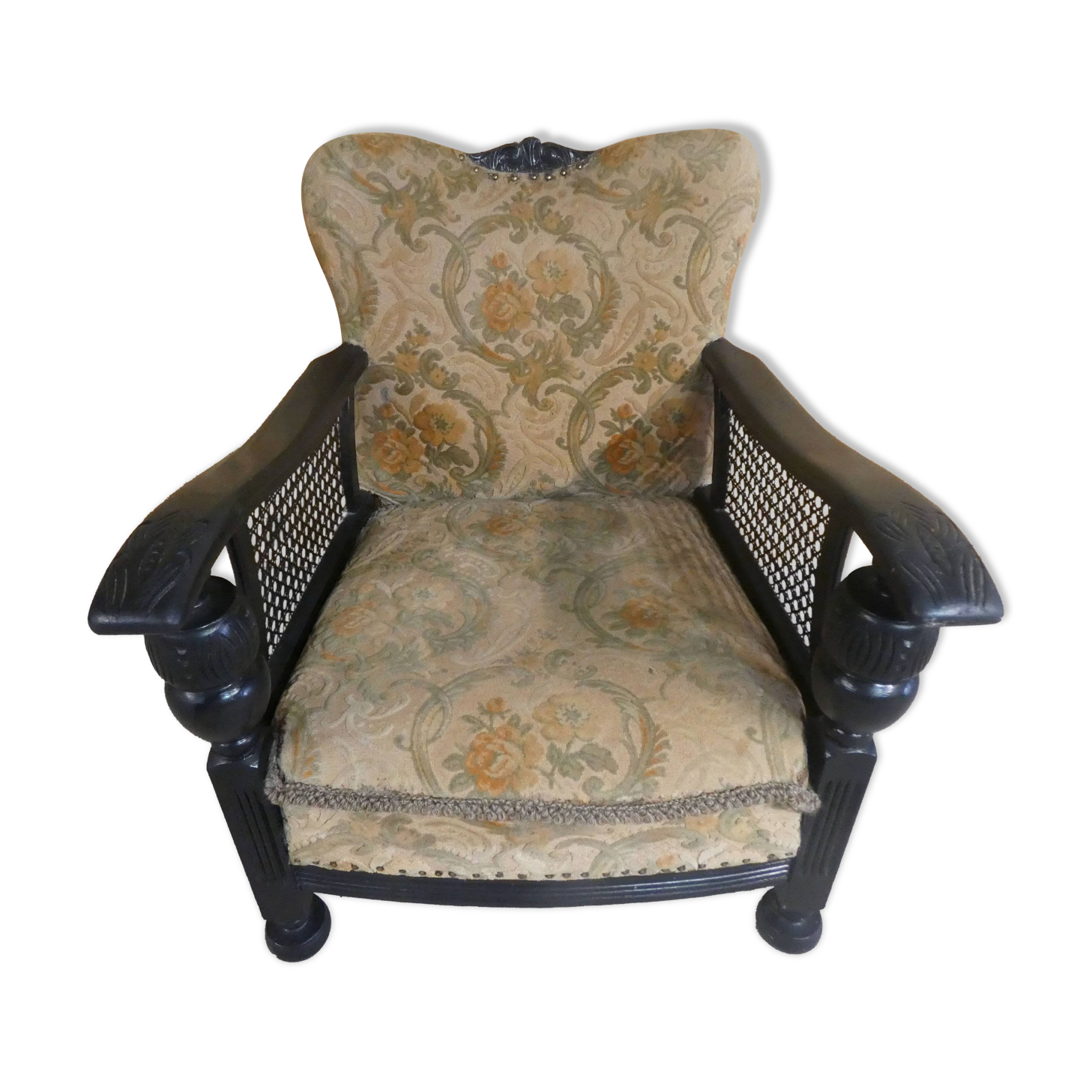 Old armchair upholstered in velvet, carved and caned wood