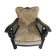 Old armchair upholstered in velvet, carved and caned wood