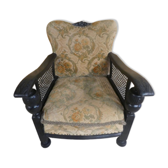 Old armchair upholstered in velvet, carved and caned wood
