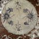 Ceramic plate signed by Marie-Madeleine Jolly – thistle decoration – year