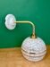 Vintage glass wall light with a curved arm in white and gold from Clichy.