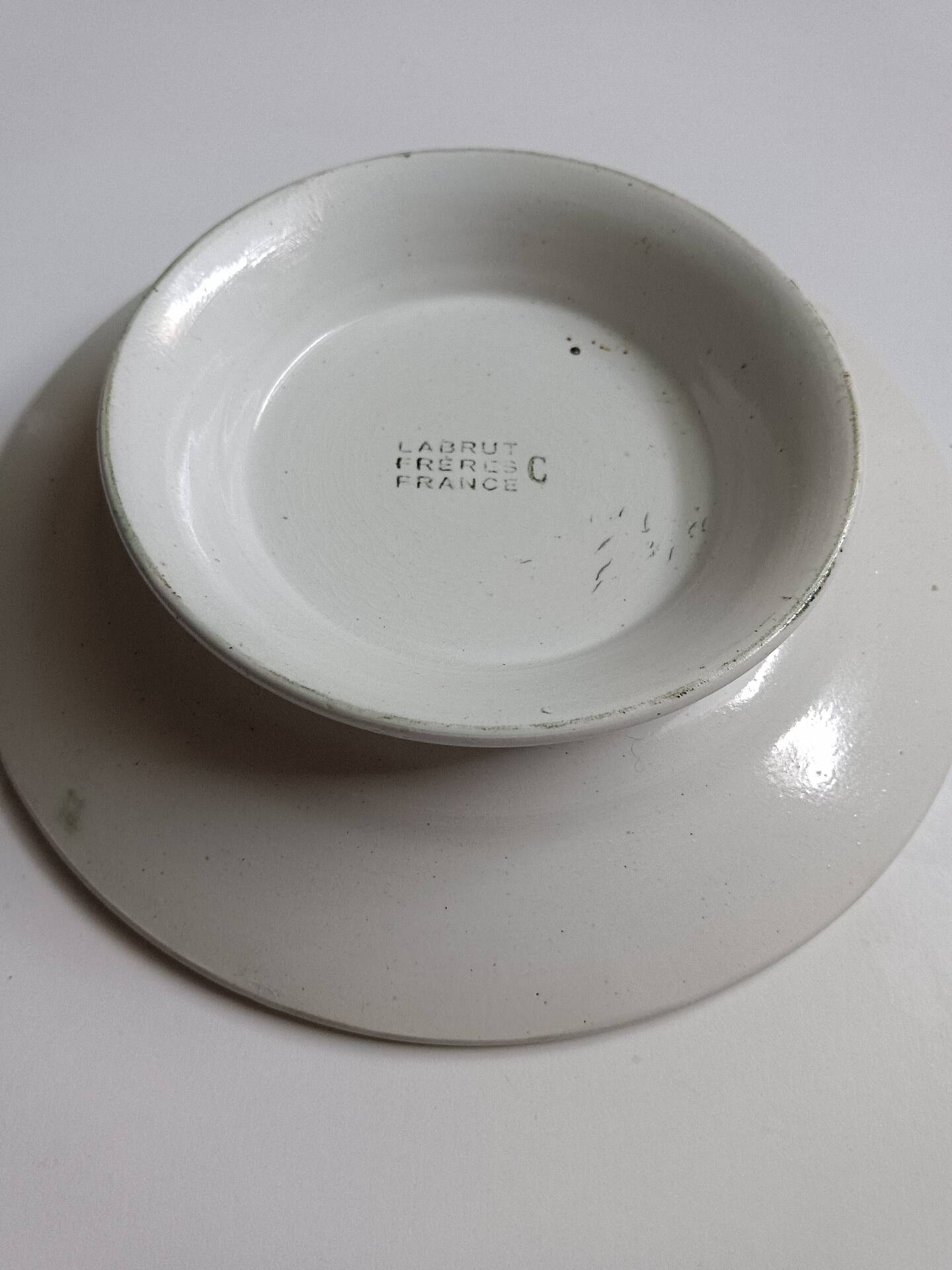 Old round footed plate signed Labrut brothers flowers