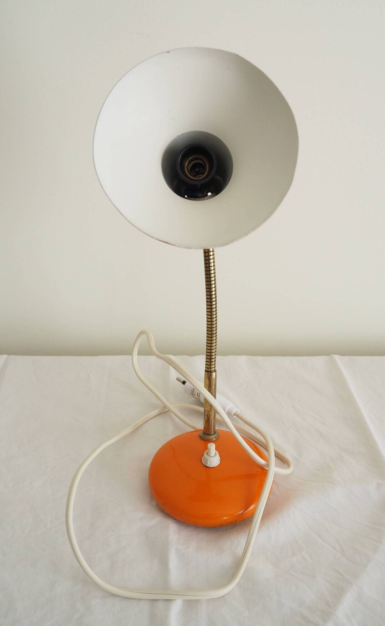 Orange colored metal desk lamp from the 1960s-1970s