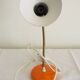 Orange colored metal desk lamp from the 1960s-1970s