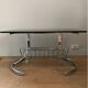 Space Age coffee table in chrome metal and smoked glass with magazine rack – Circa 1970