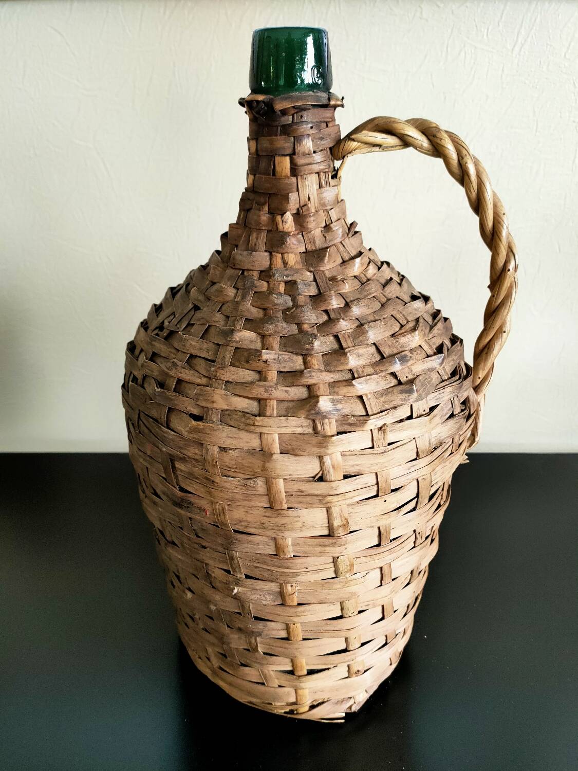 Antique demijohn made of glass and woven wicker