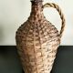 Antique demijohn made of glass and woven wicker